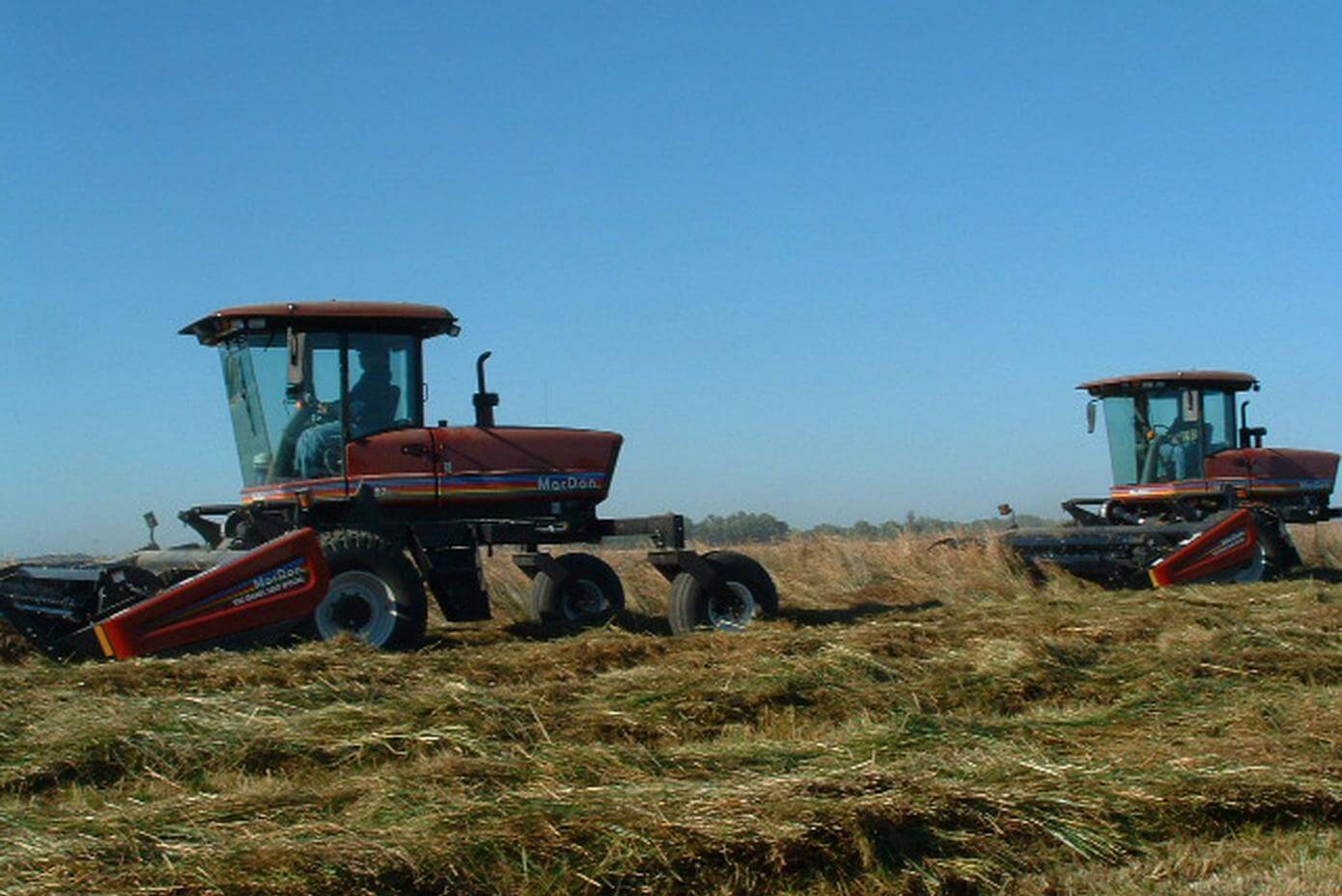 Tractors harvesting seed