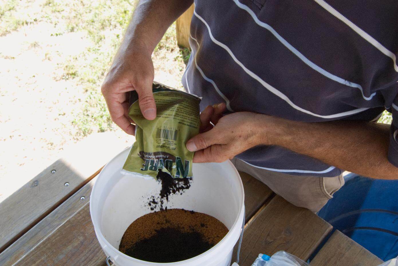 Seed being inoculated in a bucket